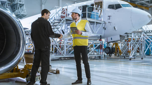 istock Engineer moving though Aircraft Maintenance Terminal Greeting a Mechanic 1167549650