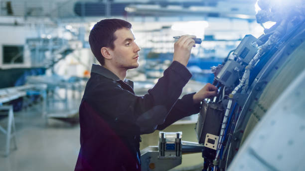 istock Aircraft Maintenance Mechanic Inspecting with Flashlight Airplane Jet Engine in Hangar 1167549681