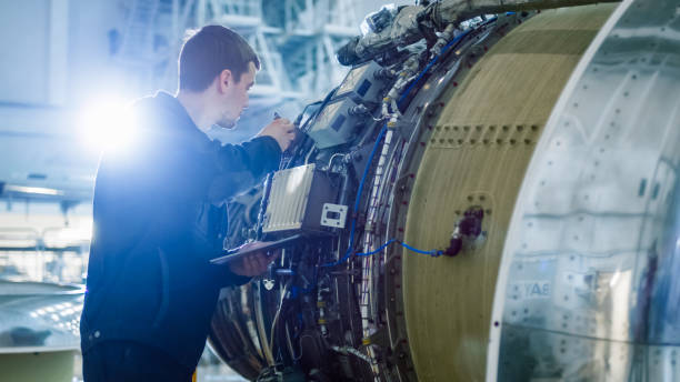 istock Aircraft Maintenance Mechanic Inspecting and Working on Airplane Jet Engine in Hangar 1167549683