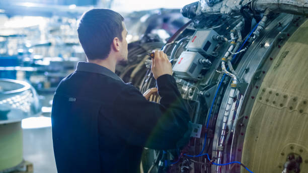 istock Aircraft Maintenance Mechanic Inspecting with Flashlight Airplane Jet Engine in Hangar 1167549684