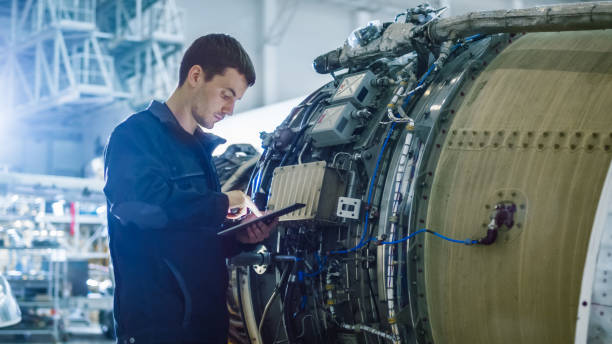 istock Aircraft Maintenance Mechanic Inspecting and Working on Airplane Jet Engine in Hangar 1167549689
