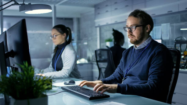 istock Caucasian Male and Female Engineers Working on a computers in a Bright Modern High-Tech Laboratory. 1167549714