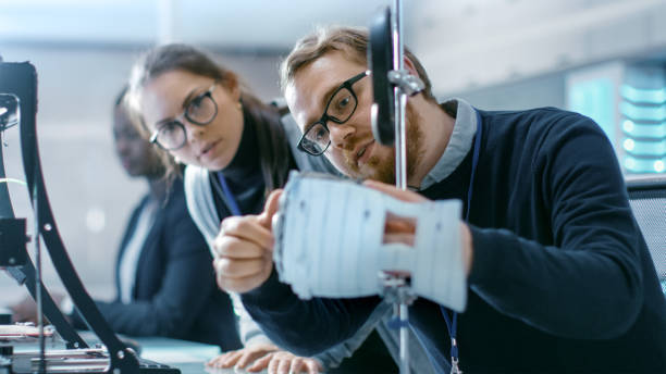 istock Young Talented Male and Female Engineers In a Modern Laboratory Construct Prototype with the Help of 3D Printer. 1167549767