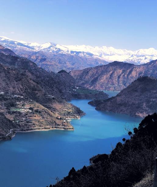 istock Blue lake with snow covered mountain 1167549881