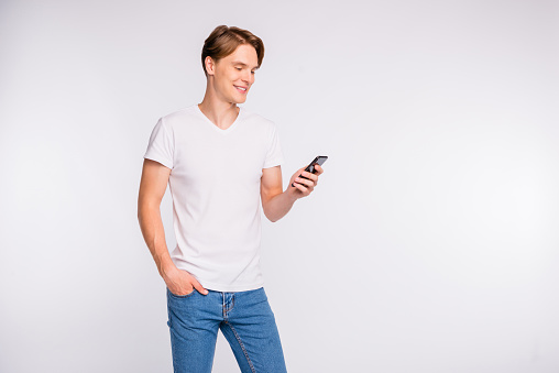 Photo of attractive guy holding, telephone hands wear casual outfit isolated white background