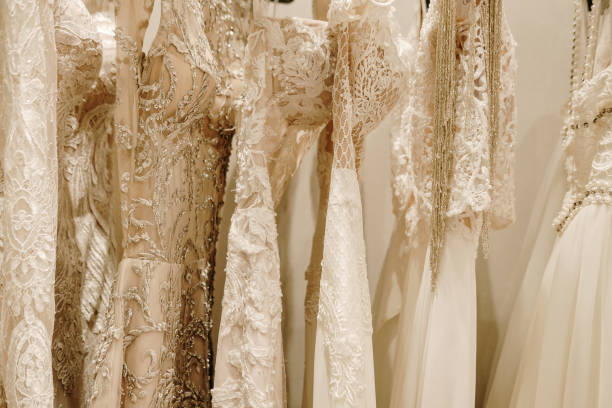 istock Cream wedding dresses hanging on the rack 1167553754