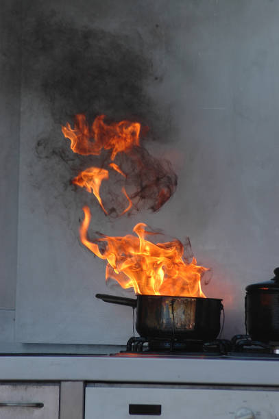 oil burning on stove flames from burning oil on a kitchen stove kitchen on fire stock pictures, royalty-free photos & images