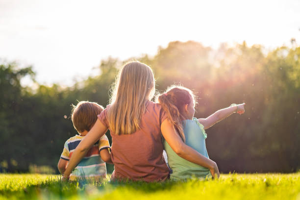 istock Rear view mother and kids enjoying nature 1167556470
