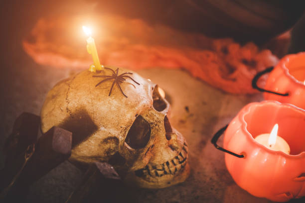 istock Halloween pumpkin with ghost skull and candle. 1167558794