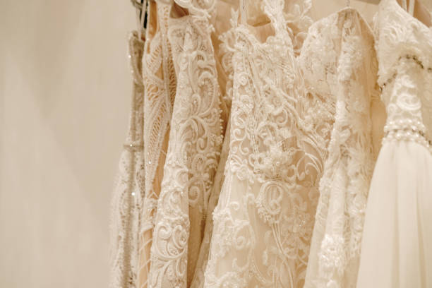 istock Cream wedding dresses hanging on the rack 1167558834