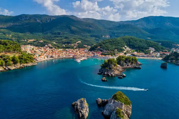 Aerial cityscape view of the coastal city of Parga, Greece during the Summer. Crystal water natural landscape and beautiful architectural buildings near the port of Parga Epirus, Greece, Europe.