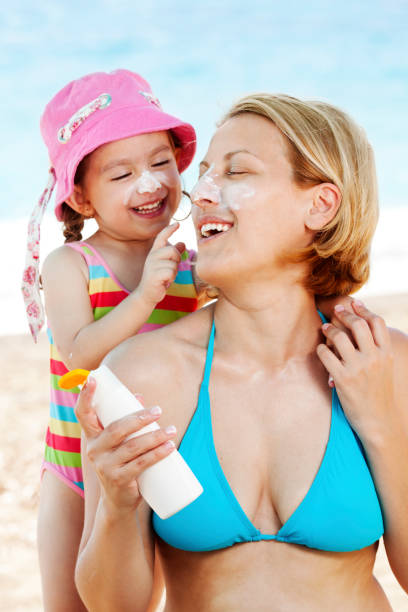 istock Child applying sunscreen on her mother's face 1167560162