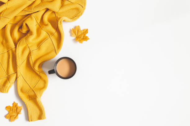 istock Autumn composition. Cup of coffee, yellow sweater on white background. Autumn, fall concept. Flat lay, top view, copy space 1167560163