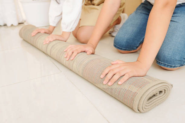 istock Children unfolding new carpet 1167560276