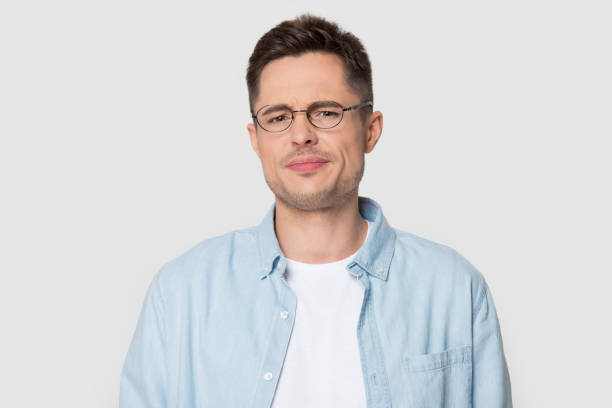 istock Headshot portrait dissatisfied frowning guy posing over studio background 1167561002