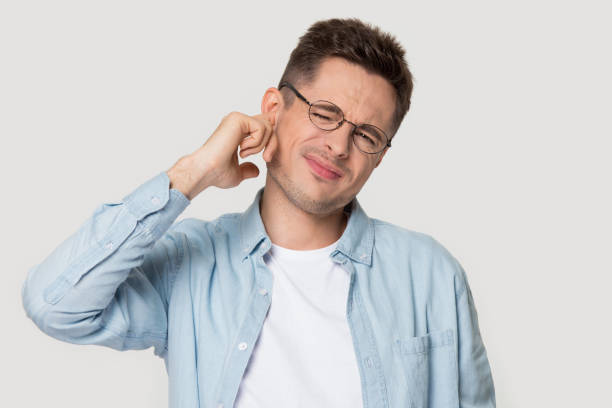 istock Studio headshot young man suffers from earache or noise 1167561025