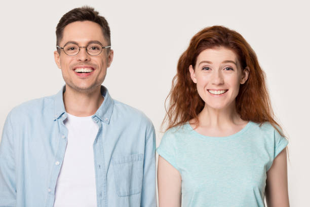 istock Headshot studio portrait millennial couple looking at camera feels happy 1167561587