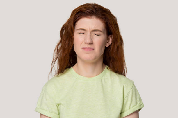 istock Redhead unhappy capricious woman closed eyes frowning eyebrows studio headshot 1167561669