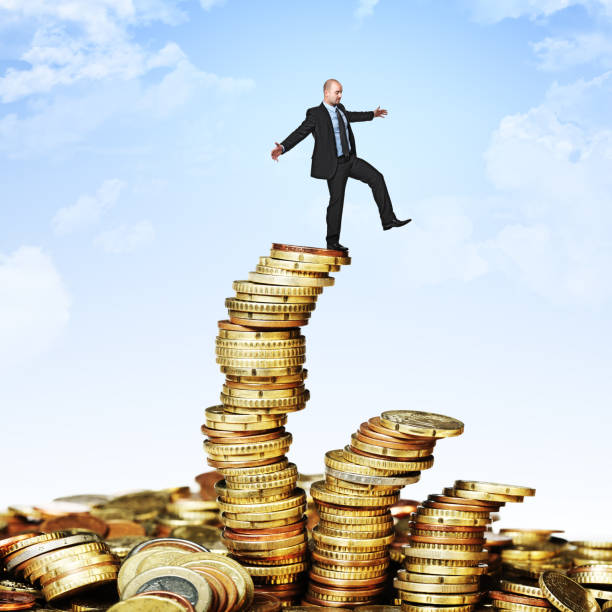 istock Digital Composite Image Of Businessman Walking On Coins Against Sky 1167563022