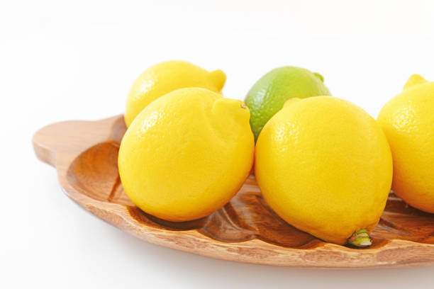 Fresh citrus fruits on a wooden tray