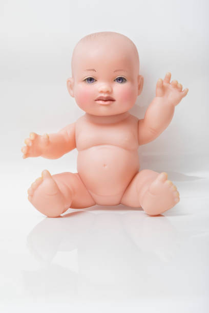 istock Baby plastic doll with real human face eyes and mouth sitting 1167568855