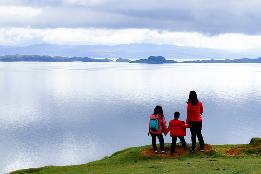 Family enjoying tranquility of nature in the morning, Spring, at Isle of Skye, Scotland