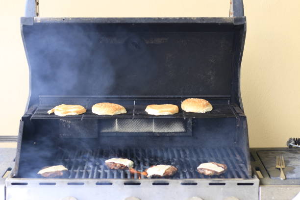 istock grilling burgers on a bbq over top a flame 1167572566
