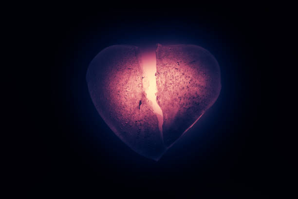 Ice Frozen Broken In Half Heart Symbol Of A Bright Red Color Closeup Glowing In The Darkness Old Vintage Style Texture Of Ice With Bubbles Symbol Of A Broken Heart Allegory Of Ice Frozen Broken In Half Heart Symbol Of A Bright Red Color Closeup Glowing In The Darkness Old Vintage Style Texture Of Ice With Bubbles Symbol Of A Broken Heart Allegory Of