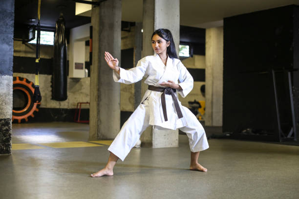 Karate word Teenage girl exercising karate. About 18 years old, mixed race female. martial arts stock pictures, royalty-free photos & images