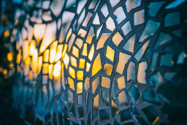 Reflection of the setting sun in the mirror pieces of glass mosaic - abstract background - very shallow depth of field