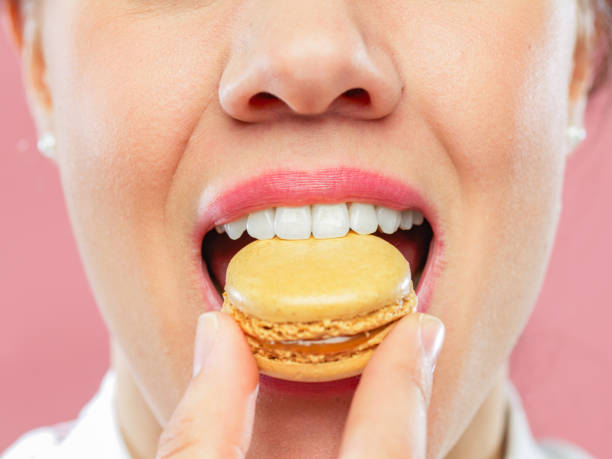 istock Young Adult Woman Biting Yummy Macaroons 1167578212