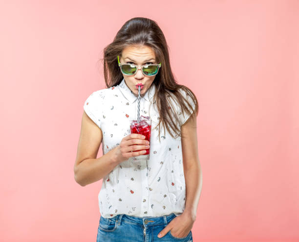 istock Stylish Young Adult Drinking Ice Team with a Straw 1167579254