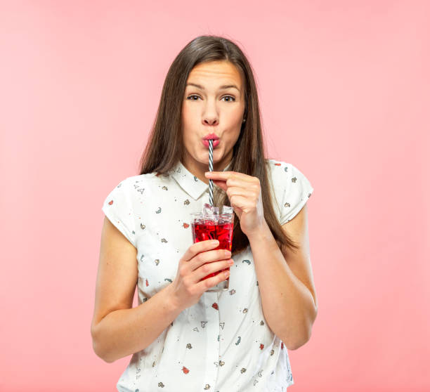 istock Attractive Young Woman Enjoys Drinking Refreshing Ice Tea 1167579296
