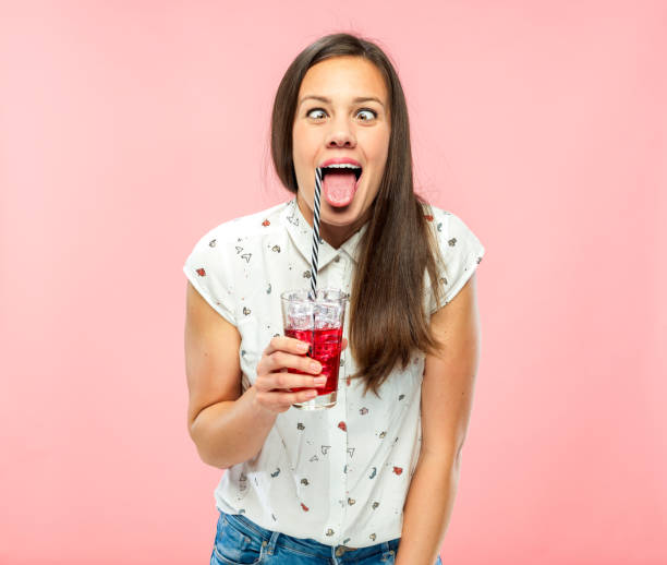 istock Playful Young Adult Squinting for Fun while Drinking Ice Tea 1167579317