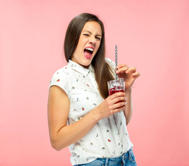 istock Goofy Young Brunette Enjoying Ice Tea 1167579322