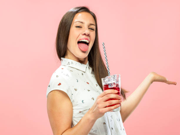 istock Goofy Young Brunette Enjoying Ice Tea 1167579323