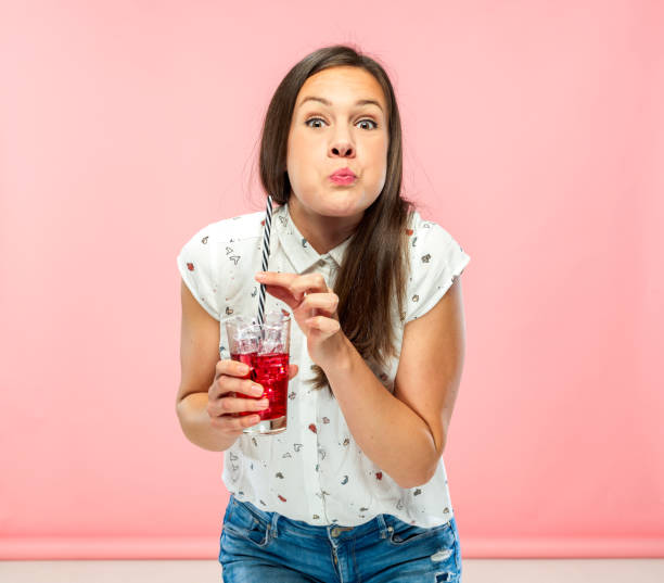 istock Goofy Young Brunette Enjoying Ice Tea 1167579327