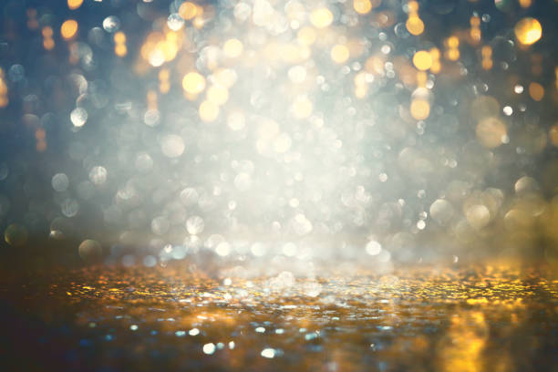 istock background of abstract glitter lights. gold and black. de-focused. 1167579625
