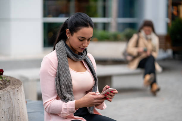 istock Businesswoman taking a break outside chatting on smartphone while sitting on bench 1167579900