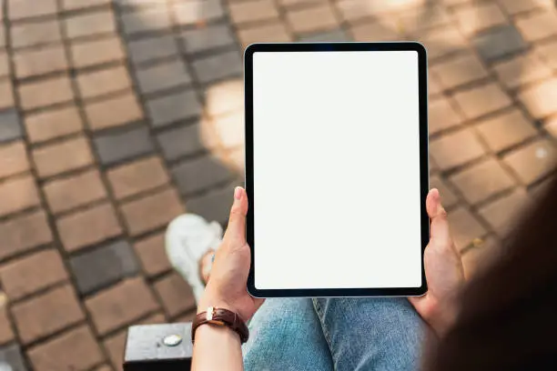 Photo of Hand holding digital tablet blank screen. mockup to screen to put products on advertising.