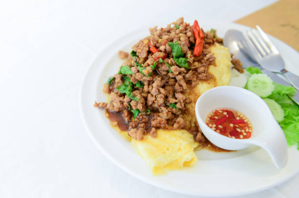 Fried basil with pork on an omelette and Fish sauce with chilli, street food and popular thai food