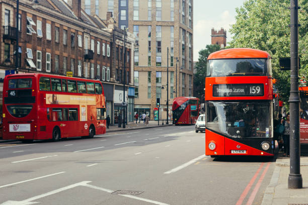 Red doubledecker bases on the streets of London London / UK - July 16, 2019: Passengers getting on a red doubledecker bus towards Streatham Station on the Brixton Road in Lambeth brixton photos stock pictures, royalty-free photos & images