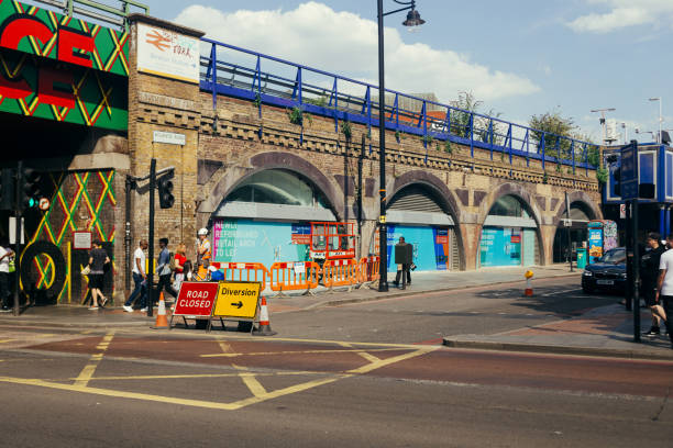Atlantic Road, London London / UK - July 16, 2019: people crossing Atlantic Road towards Coldharbour Lane on a summer day brixton photos stock pictures, royalty-free photos & images