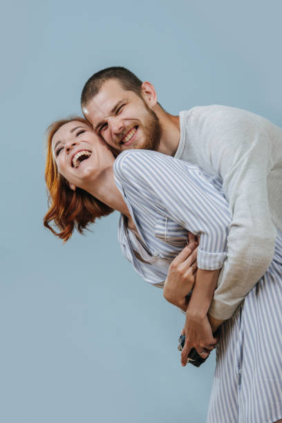 istock man with artificial limb hugs his girlfriend from the back and they are laughing 1167580895