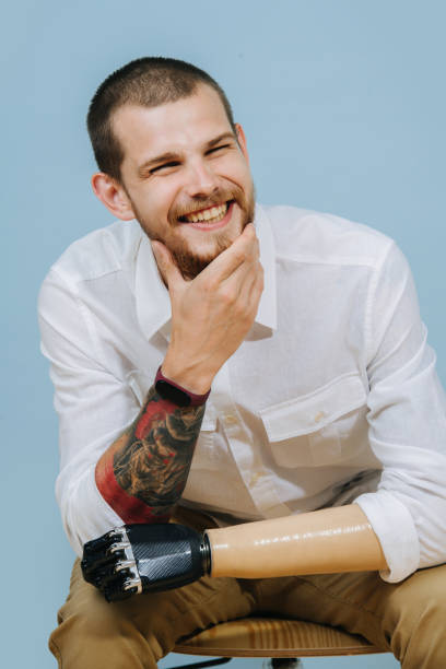 istock happy bearded guy with artificial hand looks away and smiles 1167582696