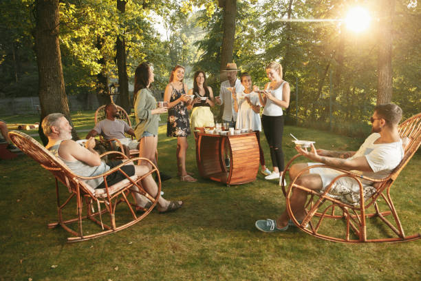 istock Happy friends eating and drinking beers at barbecue dinner on sunset time 1167583278