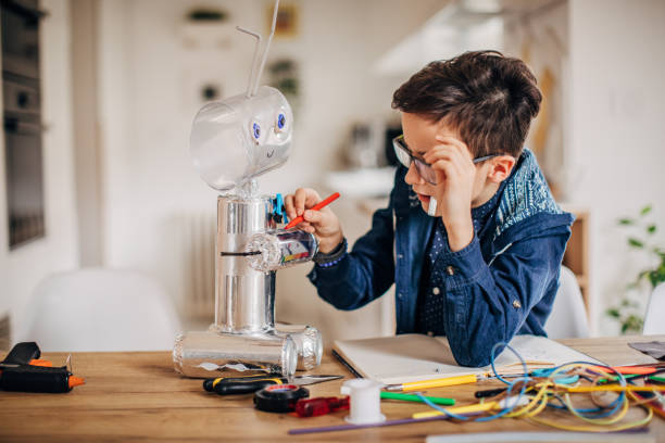 istock Boy making robot toy of recycling material 1167583488