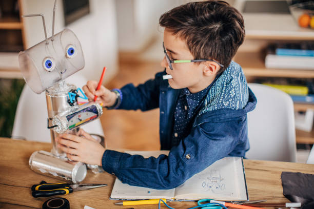 istock Boy making robot toy of recycling material 1167583908