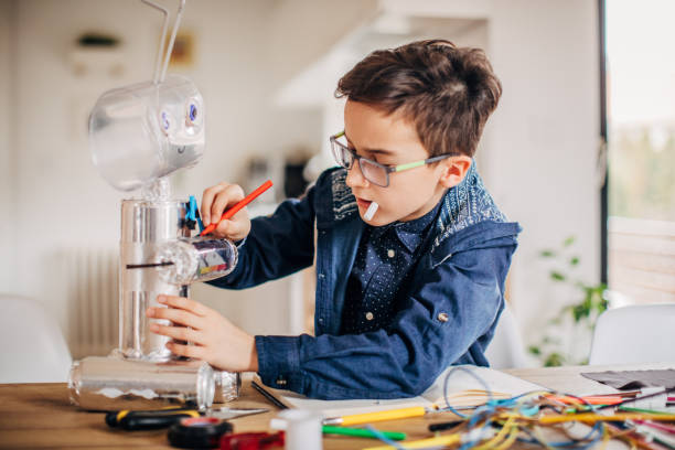 istock Boy making robot toy of recycling material 1167584599