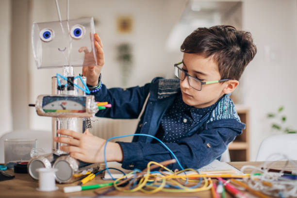 istock Boy making robot toy of recycling material 1167584773